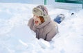 Girl lying in the snow heap