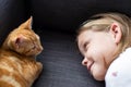 Girl Lying On Sofa At Home Looking Lovingly At Pet Cat Royalty Free Stock Photo