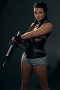 Girl with machine gun on dark background Royalty Free Stock Photo