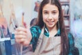 Girl of magical beauty showing painting brush for camera