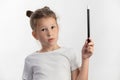 Girl magician - magic wand in child hands - young magician performing with a magic wand - against white background