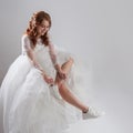 Runaway bride laces shoelaces. girl in a magnificent wedding dress and white sneakers