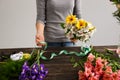 Girl make bouquet over gray background. Royalty Free Stock Photo