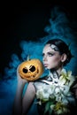 Girl with make-up for Halloween. Pumpkin