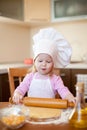 Girl makes dough on kitchen with rolling pin Royalty Free Stock Photo