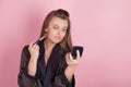 Girl makes herself makeup brush Royalty Free Stock Photo