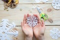 The girl makes a homemade snowflakes cut out of paper, preparation for the new year, Christmas Royalty Free Stock Photo