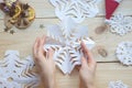 The girl makes a homemade snowflakes cut out of paper, preparation for the new year, Christmas Royalty Free Stock Photo