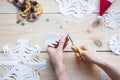 The girl makes a homemade snowflakes cut out of paper, preparation for the new year, Christmas Royalty Free Stock Photo