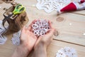 the girl makes a homemade snowflakes cut out of paper, preparation for the new year, Christmas Royalty Free Stock Photo