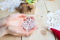 the girl makes a homemade snowflakes cut out of paper, preparation for the new year, Christmas Royalty Free Stock Photo