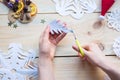 The girl makes a homemade snowflakes cut out of paper, preparation for the new year, Christmas Royalty Free Stock Photo