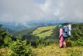 Girl makes landscape photo with help of smartphone. Landscape contains sundown over sea and mountains. Travel scene, so Royalty Free Stock Photo