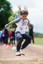 Girl makes long jump Royalty Free Stock Photo