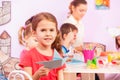 Girl makes origami in kindergarten class Royalty Free Stock Photo