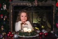 Girl makes a wish at Christmas Royalty Free Stock Photo