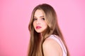 Girl with makeup and healthy hair. Fashion look concept. woman with long hair on pink background. Beauty and