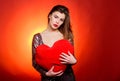 Girl makeup and decollete dress. Woman attractive fashion model hold heart toy valentines decoration. Love and