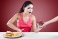 Girl Making Choice Between Burger And Strawberry Royalty Free Stock Photo