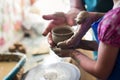 Girl making a clay bowl on sculpting wheel Royalty Free Stock Photo