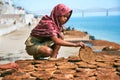 Girl making cow dung cakes Royalty Free Stock Photo