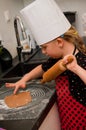 Girl making gingerbread cookies