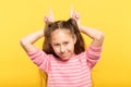 Girl making horns hands childish behavior Royalty Free Stock Photo