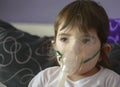 Girl making inhalation with mask on her face Royalty Free Stock Photo