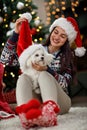 Girl making joke with her puppy for Christmas Royalty Free Stock Photo