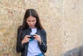 Girl making photo of historical building with camera on city street Royalty Free Stock Photo