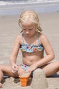 Girl Making Sand Castles at Beach Royalty Free Stock Photo