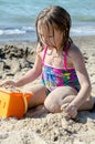 Girl making sand castles on beach Royalty Free Stock Photo