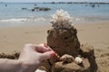 Girl is making a Sandcastle with coral on sandy beach Royalty Free Stock Photo