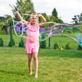 Girl making soap bubbles in home garden Royalty Free Stock Photo