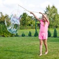 Girl making soap bubbles in home garden Royalty Free Stock Photo