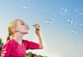 Girl making soap bubbles outside Royalty Free Stock Photo