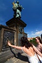 Girl making a wish. Statue of St. John of Nepomuk. Charles Bridge. Prague. Czech Republic Royalty Free Stock Photo