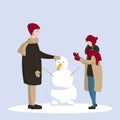 A girl and a man make a snowman on a snowy day. Winter holiday card. Royalty Free Stock Photo