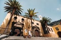 A girl and a man walk in the Old town of Garachico on the island of Tenerife on a Sunny day.A family walks through the old city of