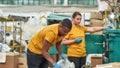 Girl and man working near rubbish pressing machine Royalty Free Stock Photo