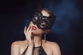 The girl in the mask. Masquerade, halloween. Girl in a cat mask. Catwoman on a beautiful background in a beautiful lace top with Royalty Free Stock Photo