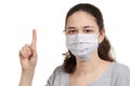 A girl in a mask shows a stop gesture fearing for the health of people