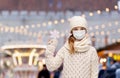 girl in mask with snowflake over christmas market Royalty Free Stock Photo