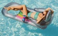 Girl on mattress on summer vacation. Summer lady girl in swimmsuit. Royalty Free Stock Photo