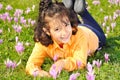 Girl on meadow with pink flowers arond