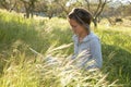 Girl on the meadow relaxing and using a laptop Royalty Free Stock Photo