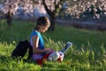 Girl on the meadow relaxing and using a laptop Royalty Free Stock Photo