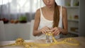 Girl measuring glass of water with tape, starving body, exhaustion, anorexia