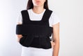 A girl in a medical brace on the shoulder joint for rehabilitation after a collarbone fracture and dislocation. Shoulder
