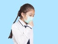 Girl in a medical mask coughing.Isolated on blue background